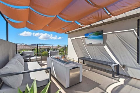 Private rooftop deck with outdoor dining table, lounge area, smart TV, and gas firepit under a canopy. Includes a built in gas BBQ grill and sink. (4th Floor)