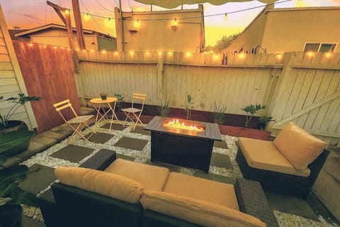 Private patio with string lights, outdoor seating and cozy firepit