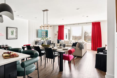 Black dining table seats the crew together right next to the living room TV, so you can cook, eat, and catch the game without anyone missing a beat
