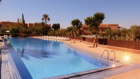 Spacious Outdoor Pool with Palm Trees