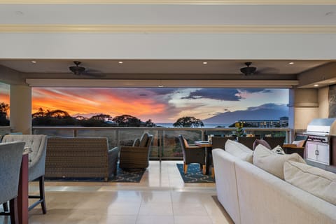 Relax in this stylish open-air lounge featuring plush seating, a built-in grill, and sweeping sunset vistas. Perfect for unwinding or entertaining in comfort and style