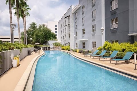 Dive into sunlit serenity beside the sparkling outdoor pool.