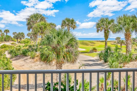 Step out onto your private balcony to enjoy stunning views of the blue ocean horizon paired with the lush greenery of a manicured golf course. This bright, tropical landscape creates the perfect coastal retreat for your next stay.