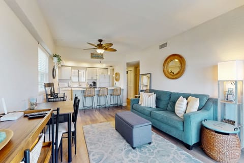 Living room with natural light, coastal décor, and comfortable seating—perfect for relaxing after a day in the sun.