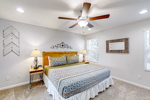 A tranquil upper-level oasis featuring a walk-in closet, streaming TV, and an en-suite bathroom with a spacious walk-in shower.