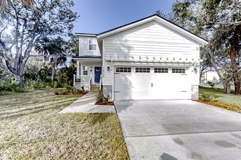 Welcome to this spacious coastal home.  Surrounded by mature trees and lush landscaping, it offers a peaceful setting just minutes from the beach and local attractions.