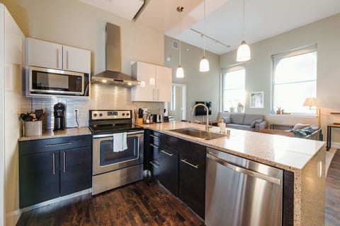 A fully-equipped kitchen featuring high-end finishes and bar seating—everything you need to prep, cook, and refuel