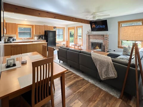 Bright main level with the kitchen, dining, and living areas flowing together.