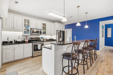 Cook up your favorite dishes in the fully equipped kitchen with sleek appliances and counter bar seating.