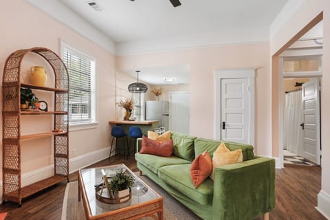 This sweet Georgia peach apartment living space features calm green decor.