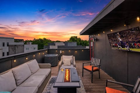 Private rooftop deck with outdoor lounging areas, fire pit, smart TV, and bistro lighting. (4th Floor)