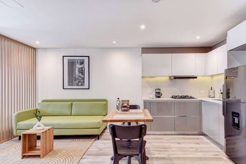 Living room with green sofa and stylish decor