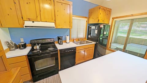 The kitchen with classic pine cabinetry, and a full set of appliances