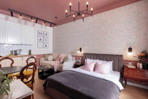 This welcoming room features a comfortable queen size bed and a convertible sofa bed, making it ideal for couples, families, or small groups. A fully equipped kitchen is part of the space, allowing you to prepare meals.
