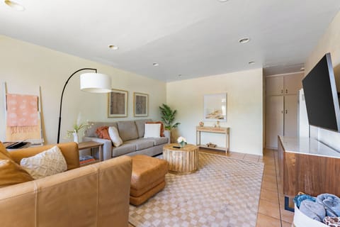 Cozy living room with warm tones, comfy seating, and stylish decor.
