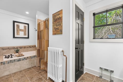 Main level Full bath and laundry location behind living room. Jetted tub.