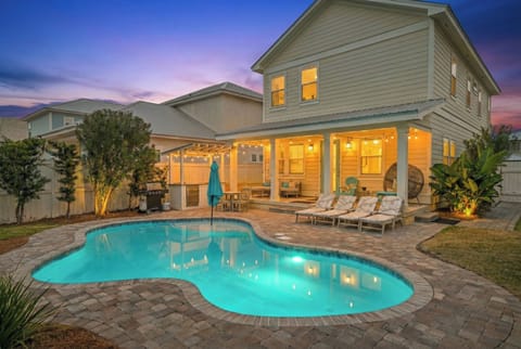 Heated pool, patio, and backyard at dusk—perfect for evening swims and outdoor entertaining.