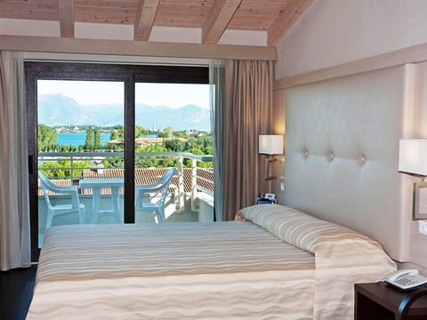 Suite, Lake View | Minibar, in-room safe, blackout drapes, iron/ironing board