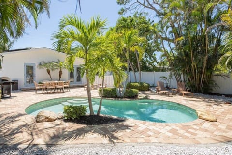Private custom heated pool at the AMI villa—palms, loungers, and beach steps away.