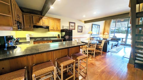 The Mt. Bachelor Retreat - Main Floor- Kitchen with 4 stools and dining adjacent