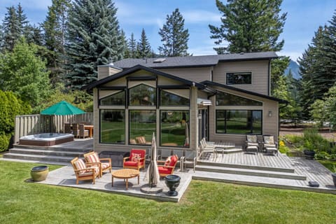 Backyard of the Alpine Lake House; enjoy the private hot tub, multiple outdoor seating options with mountain and lake views.