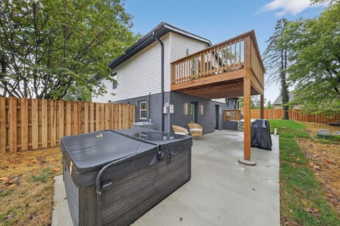 Enjoy a new concrete patio with a relaxing hot tub, perfect for unwinding outdoors. The space also features comfortable seating and a shaded area, making it ideal for gatherings or quiet evenings in your private backyard.