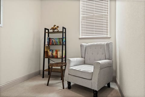 Curl up with a good book in this quiet reading nook, perfect for unwinding.