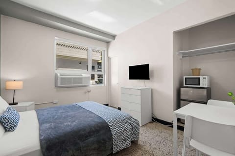 Fresh and functional! This modern bedroom boasts a comfortable queen bed with stylish bedding, providing a chic yet relaxing space for your stay.