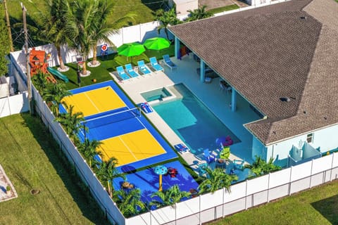 Outdoor Paradise: Dive into fun with vibrant games, a sparkling pool, and lush palm views!