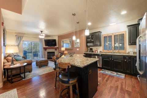 Kitchen offers granite counters, hardwood floors, and comfortable dining space
