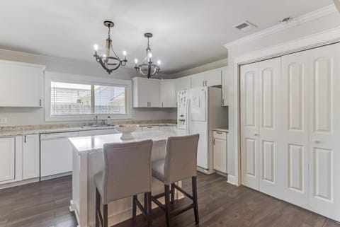 Spacious kitchen with ample counter space, modern appliances, and seating for casual dining.