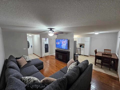 Living Room, new sectional, 65" TV, ceiling fan, electric fireplace heater.