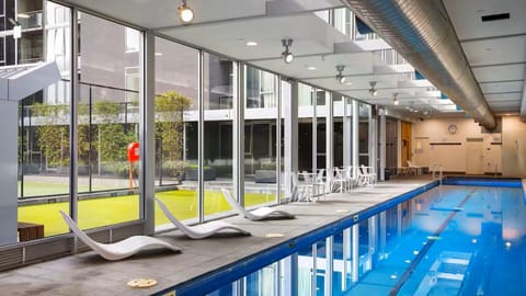 Enjoy a refreshing dip in the sleek indoor pool with lounge seating.