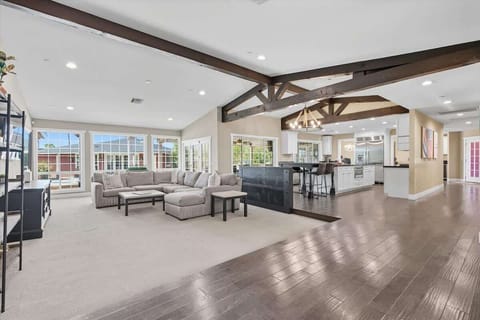 Open living area featuring designer furnishings, a Smart TV, and access to the backyard.