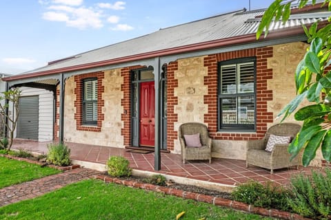 Pause on the front veranda seating, an inviting place to sip coffee and watch the village quietly come to life.