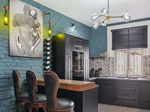 Furniture, Interior Design, Kitchen, Wall, Flooring, Countertop, Light Fixture, Cabinetry, Wood, Floor