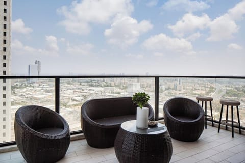 Relax on the balcony lounge with sweeping ocean views just steps from shops and train access.