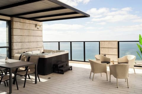 Expansive terrace invites sunset lounging, with jacuzzi moments and ocean views elevating every relaxing evening.