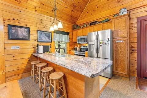 Full kitchen and stainless steel appliances and counter seating for 4