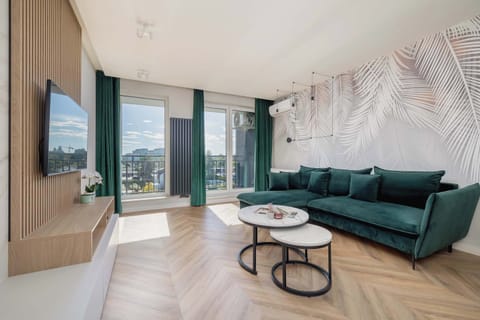 Relax in the stylish living room with a comfortable sofa and modern decor.