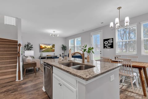 Open kitchen flows to living area, cook and connect without missing the fun