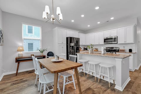 Bright, inviting space with dining and island, great for meals and memories.