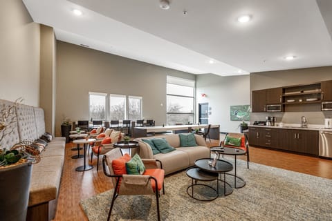 Open-concept living & dining area w/ cozy seating, wood floors, & a spacious kitchen perfect for gathering
