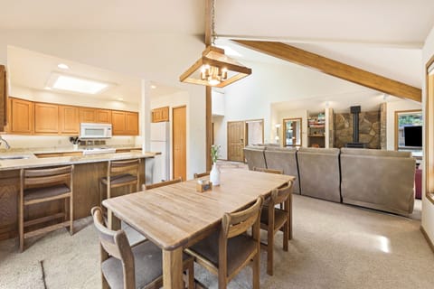 The dining table seats 6 plus two more at the bar