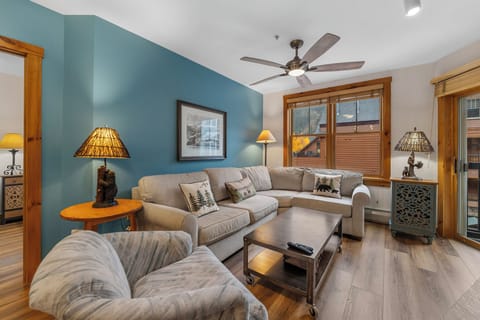 Unwind in your cozy living room where warm wood touches and soft sectional seating create the perfect spot for relaxing evenings together.