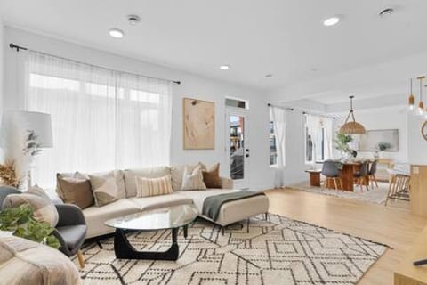 Spacious living room with 55" Smart TV and complimentary access to 20,000+ Live TV channels, latest movies, and shows via the Tivimate app, 
board games, and access to balcony with 3-piece Acapulco bistro patio set and a Napoleon Natural Gas BBQ
