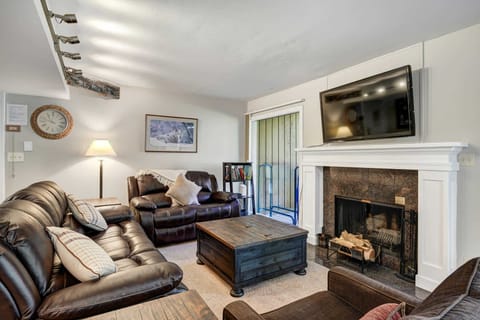 Cozy living room with a fireplace, TV, and mountain decor perfect for four guests to relax.