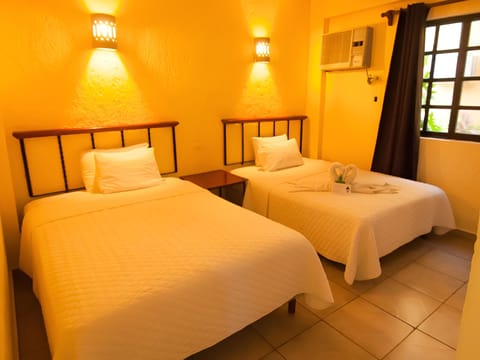 Unwind in a warm, inviting twin room with soft lighting.
