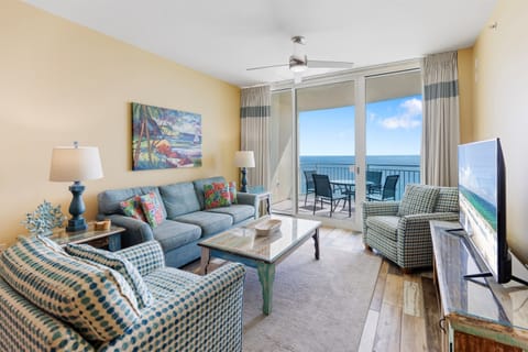 Unwind in your bright oceanfront living room with panoramic sea views through floor-to-ceiling windows and comfortable seating.