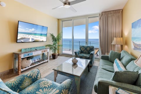 Relax in your oceanfront living room where panoramic sea views through floor-to-ceiling windows create the perfect backdrop for unwinding.